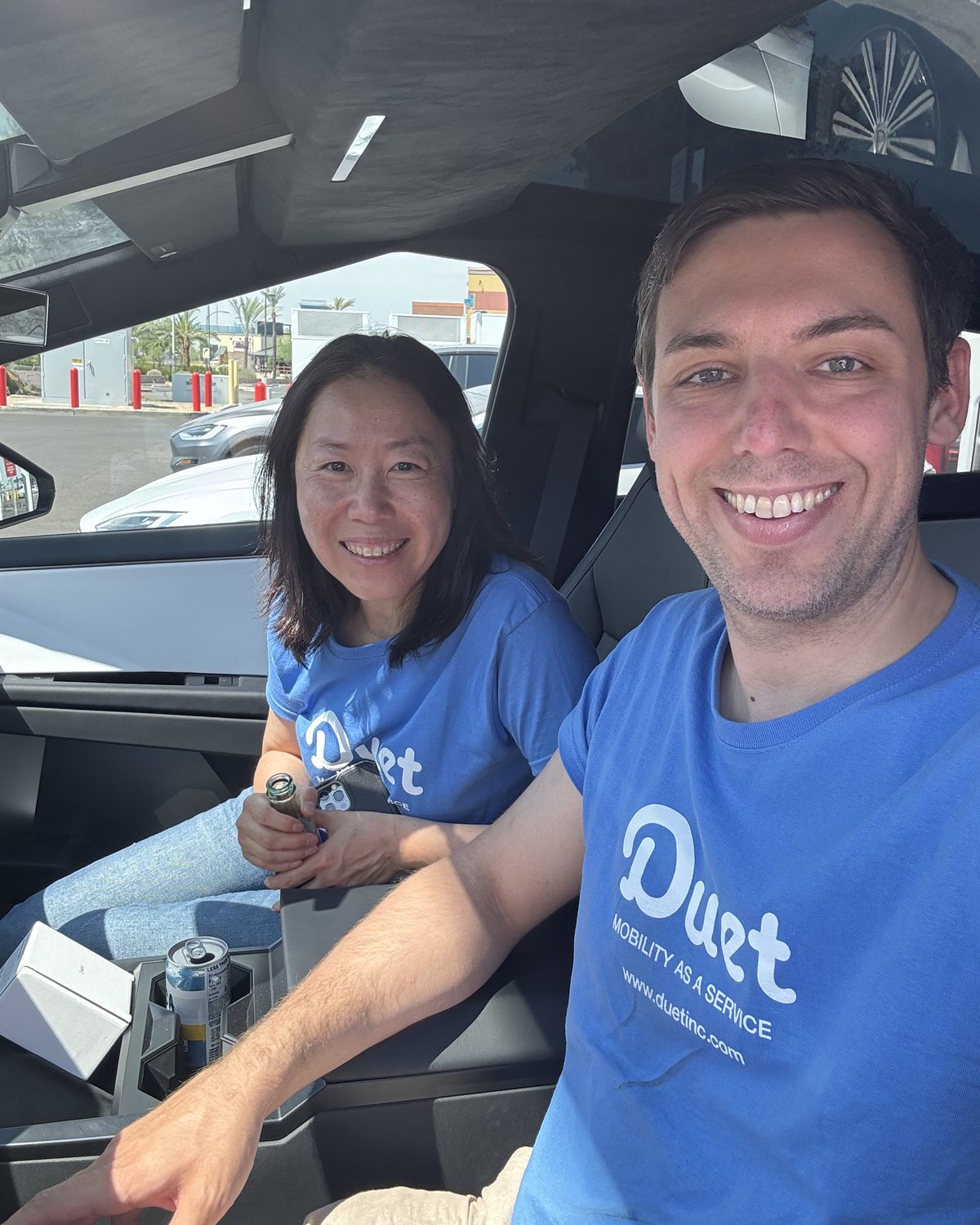 Duet cofounders Jing Zhu and James O'Donnell smiling in matching Duet t-shirts