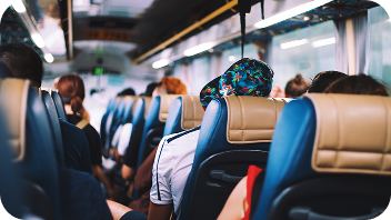 Riders seated inside a medical transport shuttle